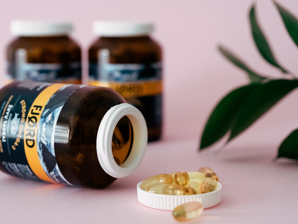 Assorted dietary supplement bottles with capsules in organized display